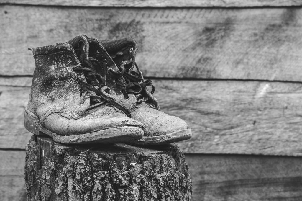 grayscale picture of old boots