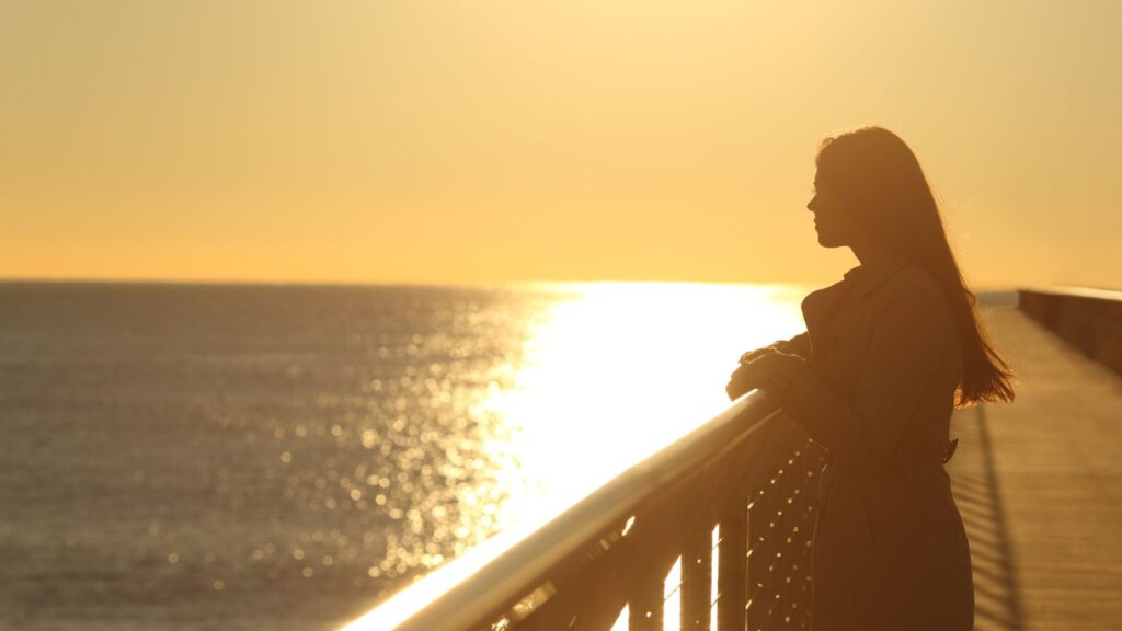 self-care; woman alone on a boardwalk; isolation concept